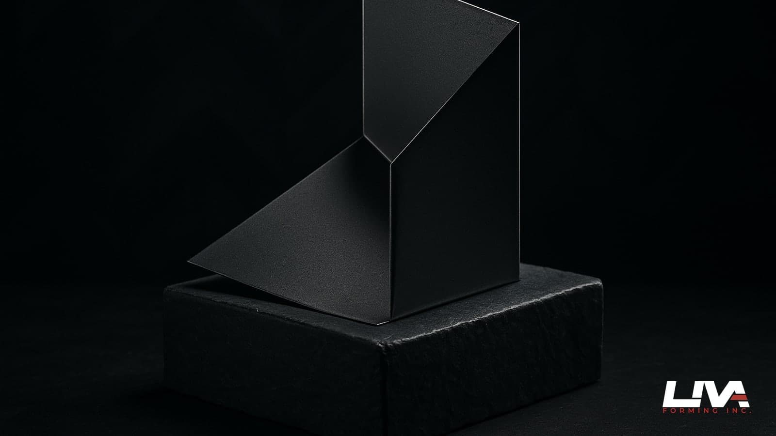Graphite metal kick-out flashing with a crisp diverter fold lit against a dark background