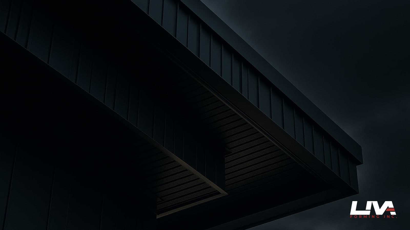 Close-up of dark metal soffit and fascia trim along a modern eave at dusk