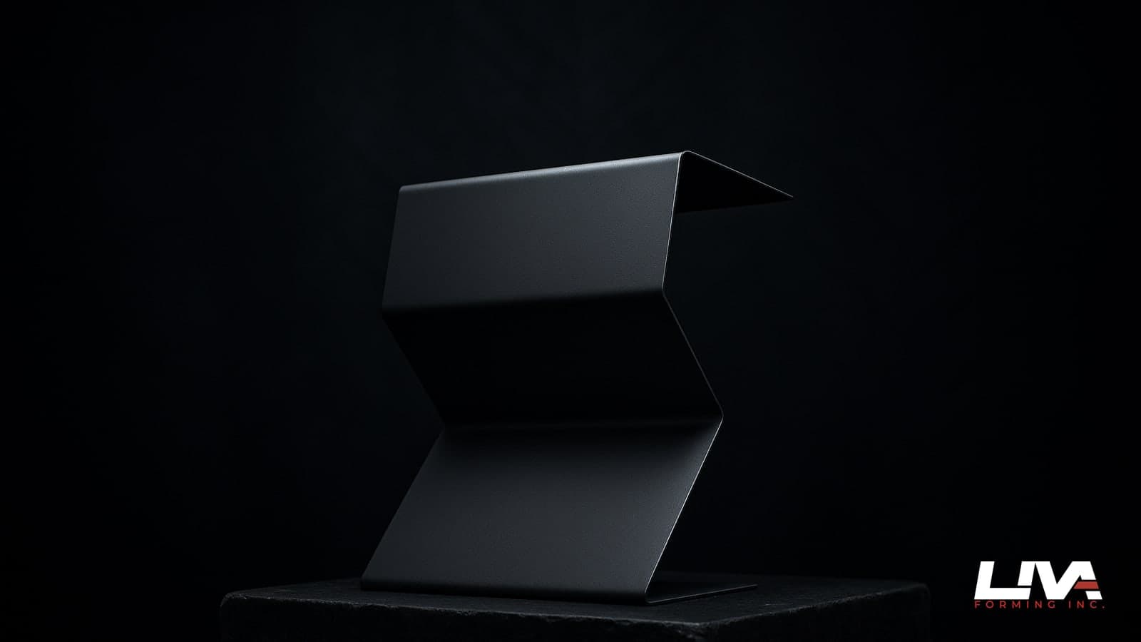 Graphite Z-shaped metal flashing profile on a stone plinth under dramatic rim lighting